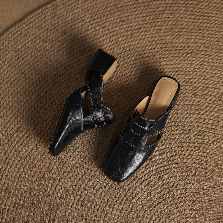 Black leather mules with adjustable strap detail and low block heel