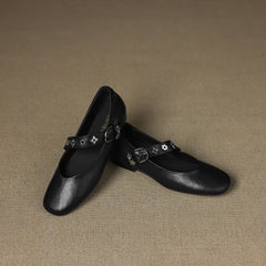 Black leather flats with decorative star strap and small buckle closure
