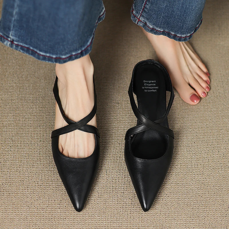 Black genuine leather mules with pointed toe and T-strap slingback on model