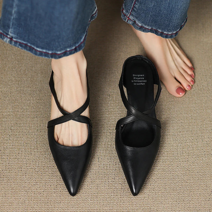 Black genuine leather mules with pointed toe and T-strap slingback on model