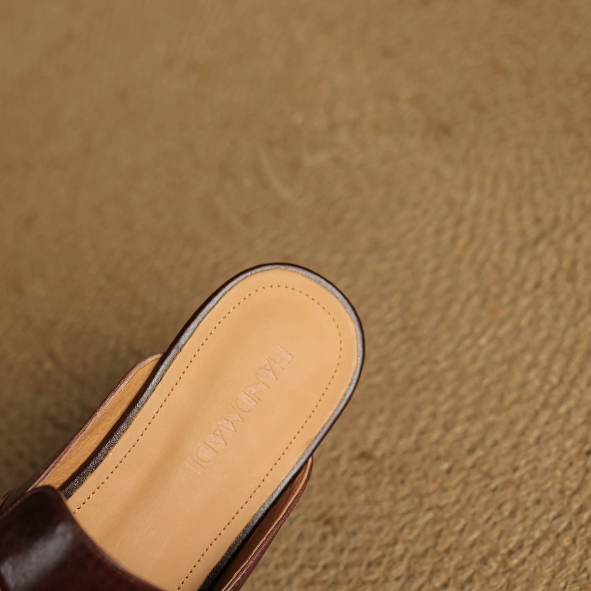 Maroon leather mule outsole view with embossed insole branding