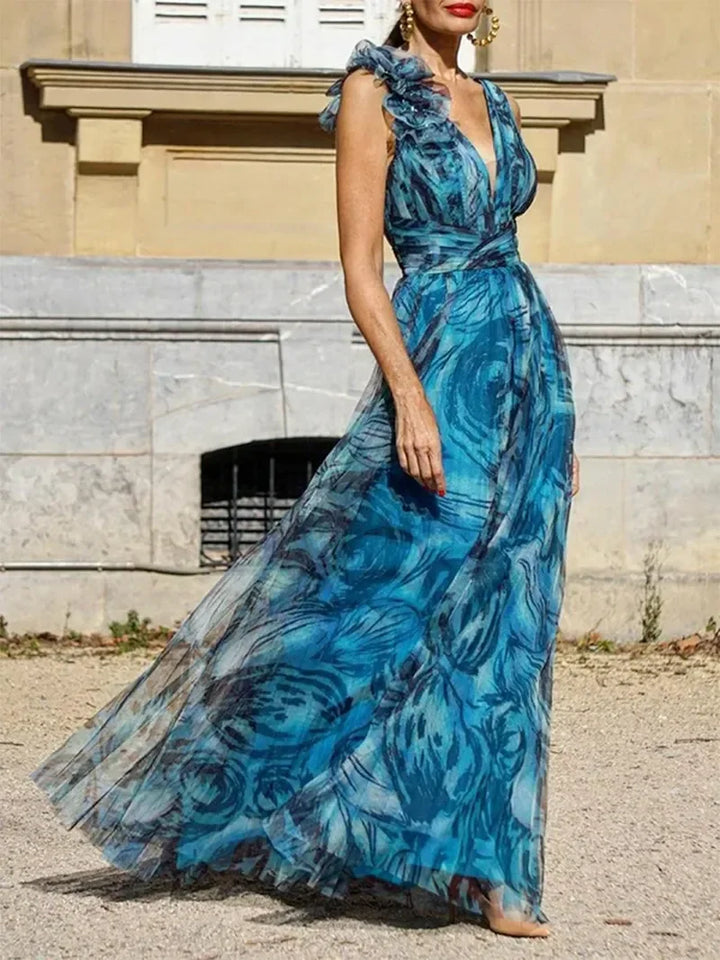 Peacock blue maxi dress with V-neck, sleeveless bodice, and flowing tiered skirt