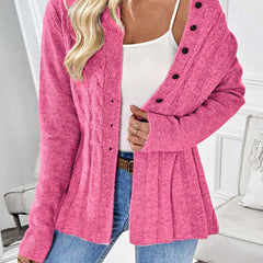 Pink ribbed cardigan with button front, long sleeves, and peplum hem