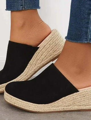 Black slip-on wedge sandals with textured jute sole and wide cushioned strap