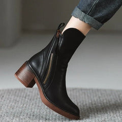 Black ankle boot with side zipper, tassel pull, and block heel