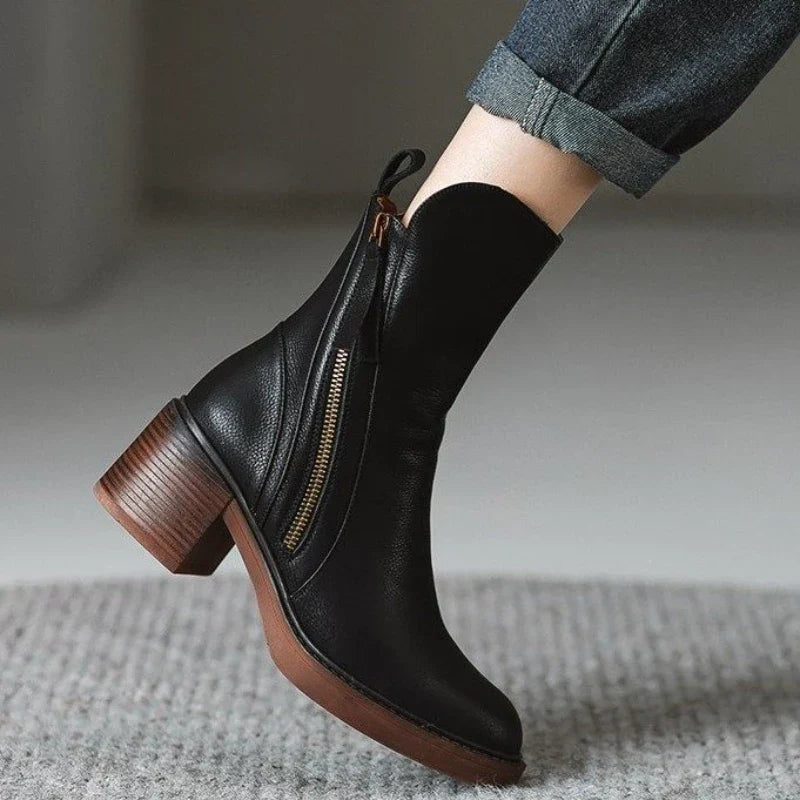 Black ankle boot with side zipper, tassel pull, and block heel