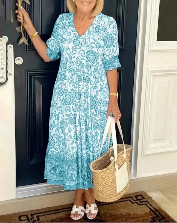 Teal floral V-neck dress with short sleeves and gathered tiered skirt