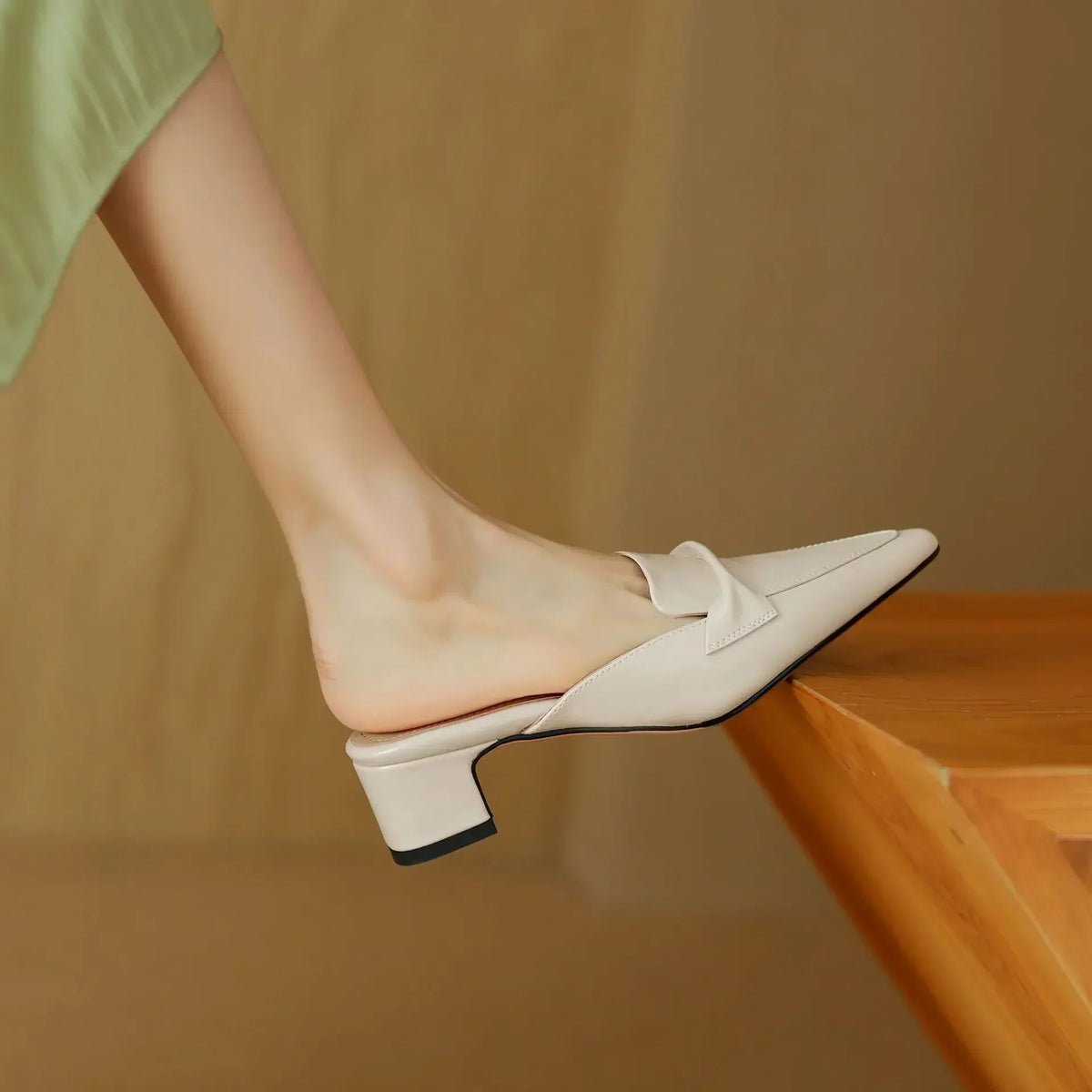 Beige mules with slip-on strap and low block heel, side view