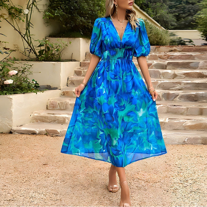 Blue V-neck midi dress with puff sleeves and ruched waist, bright floral pattern.