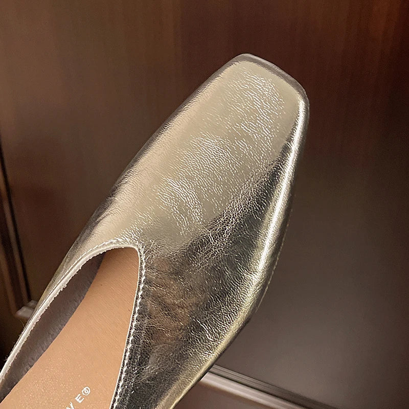 Lyra mules in shiny silver metallic with open back and low block heel
