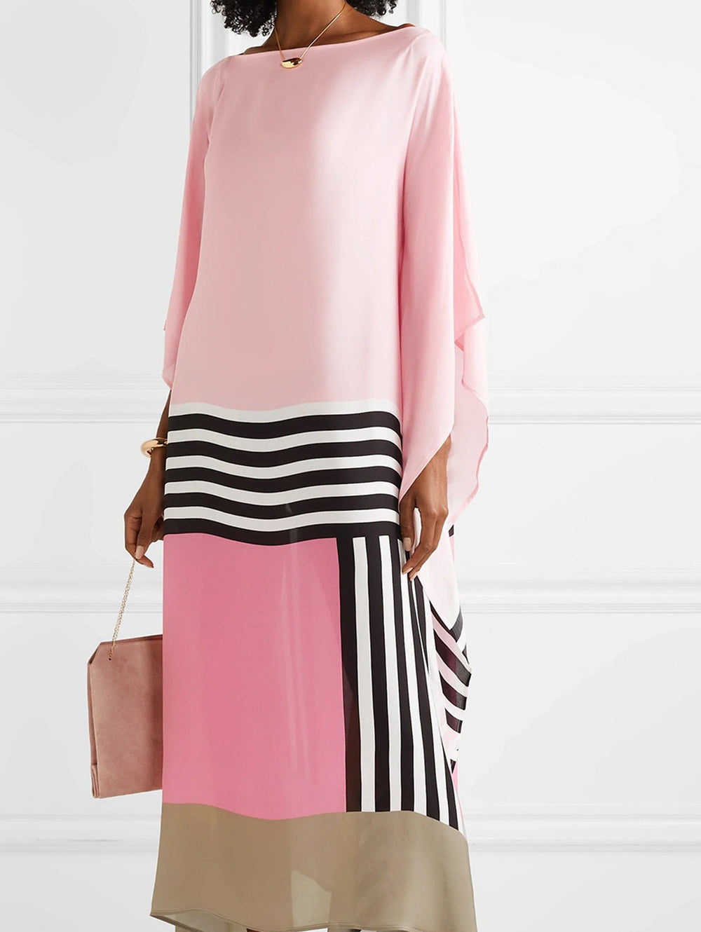 Pink geometric kaftan with wide sleeves, black-and-white striped panel, draped hem