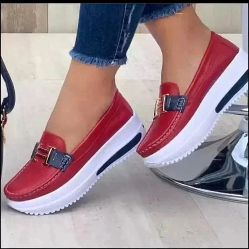 Sleek orthopedic loafers, red slip-on with buckle strap and white sole.