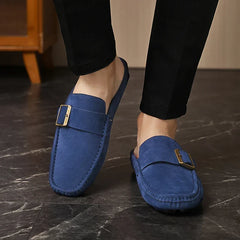 Blue suede mules with square buckle strap, low slip-on shoe on feet