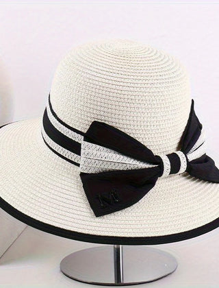 Ivory wide brim sun hat with black band, striped tie, and bow