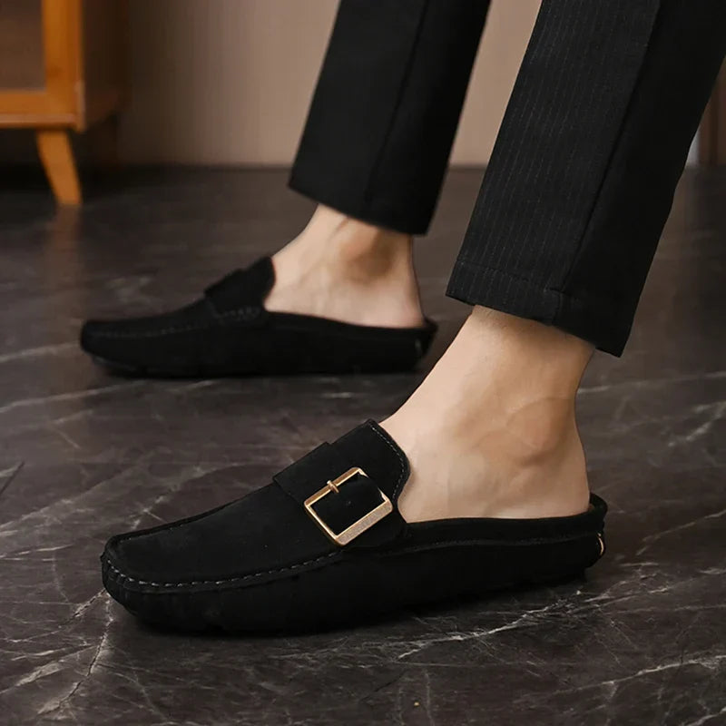Black suede mules with square buckle detail and low slip-on profile