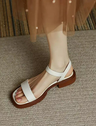 White leather platform sandals with open toe and ankle strap