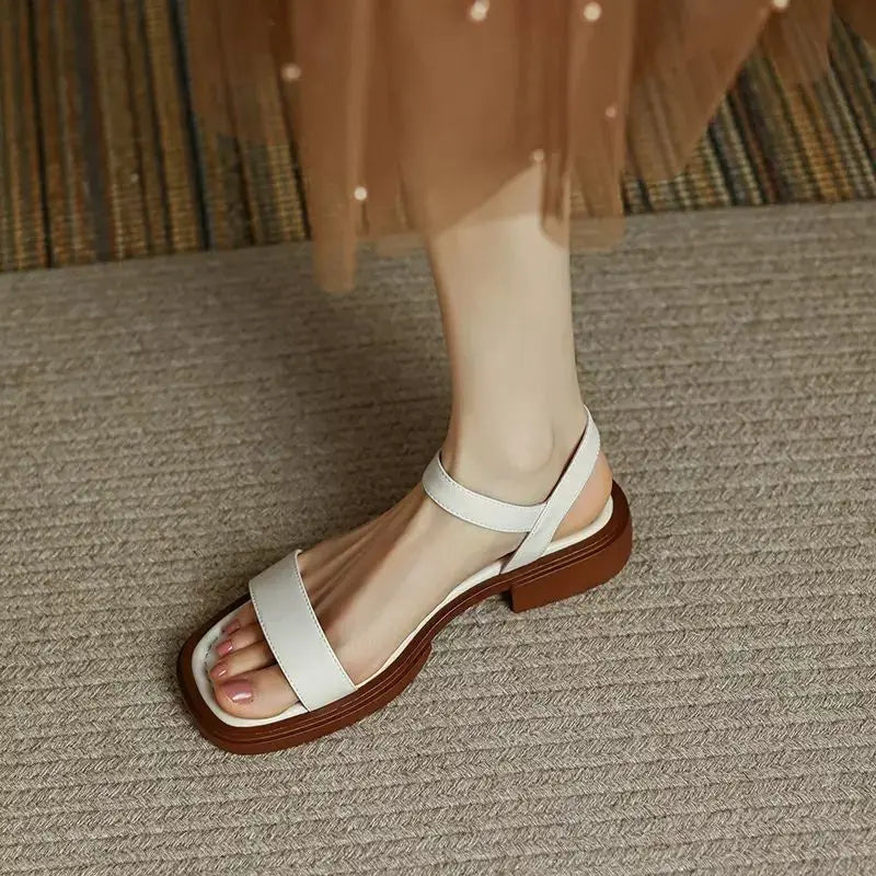 White leather platform sandals with open toe and ankle strap
