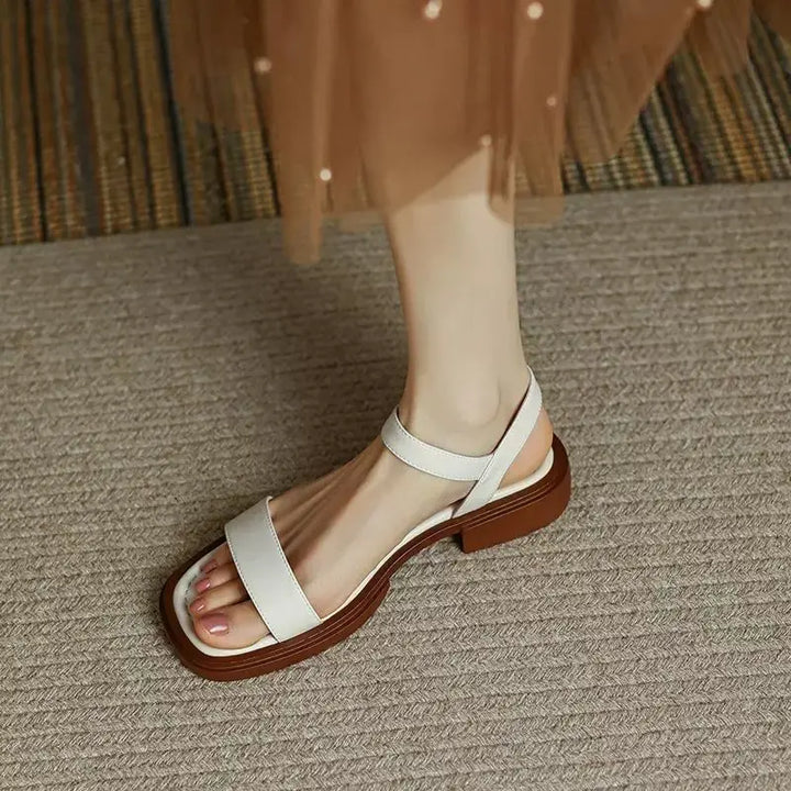 White leather platform sandals with open toe and ankle strap