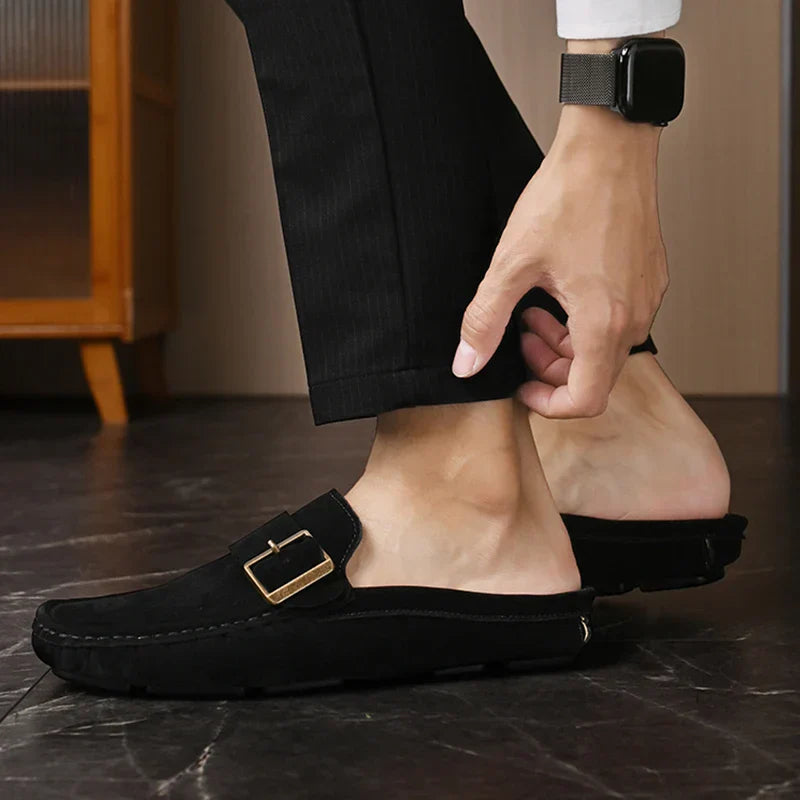 Black suede mules with square metal buckle on strap, low slip-on style