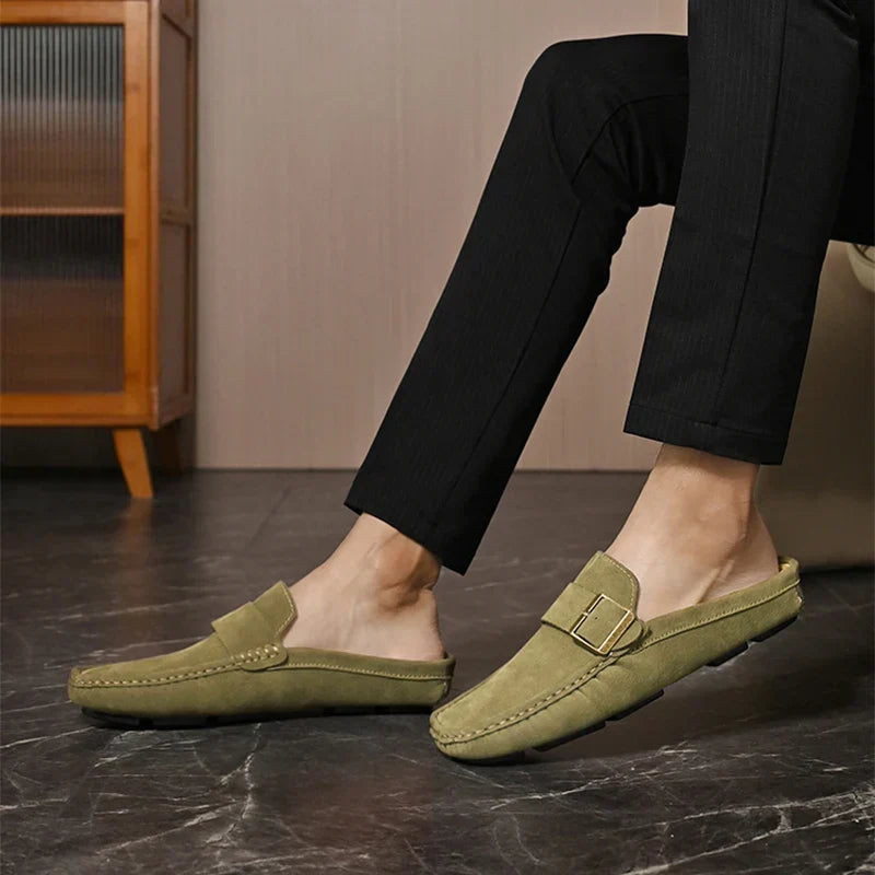Olive green suede mules with square metal buckle and stitched edges, slip-on