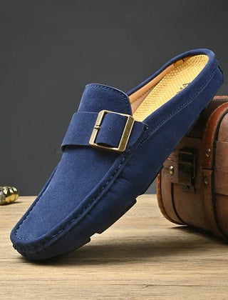 Blue suede mules with square metal buckle detail and low slip-on sole