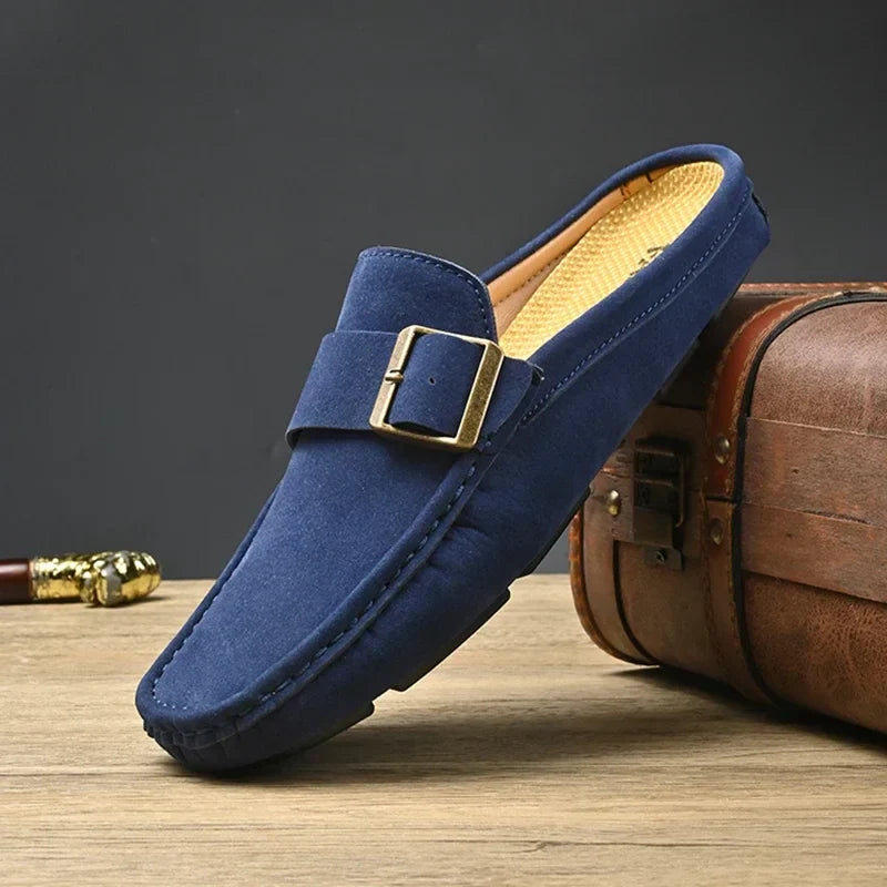 Blue suede mules with square metal buckle detail and low slip-on sole