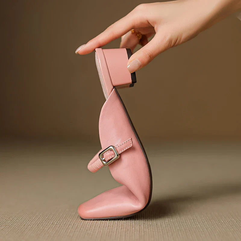 Pink Mary Jane mule with elastic strap, square buckle, and low block heel detail