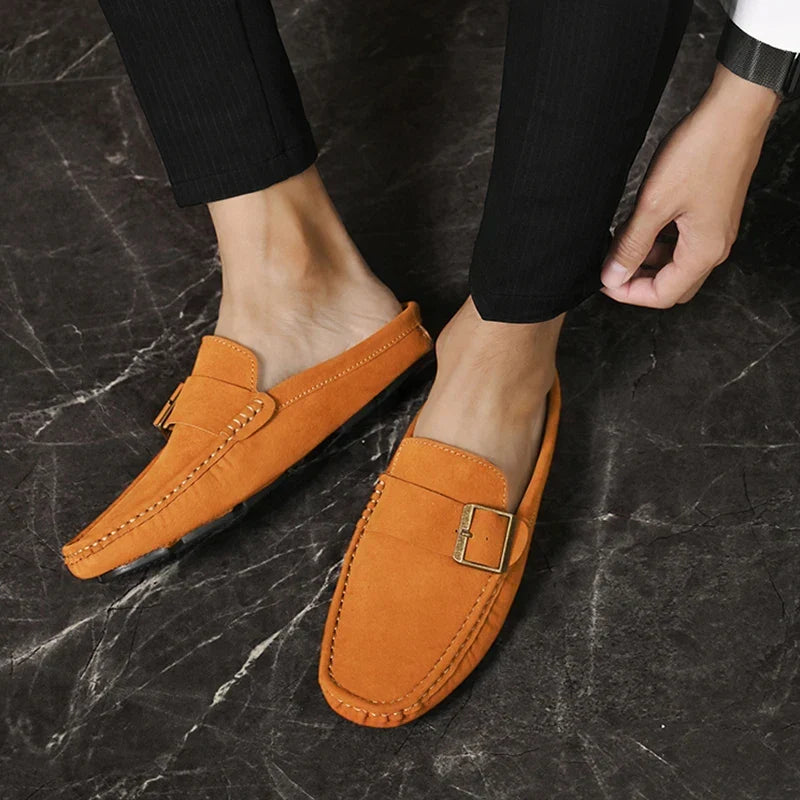 Tan suede mules with square buckle strap and contrast stitched trim