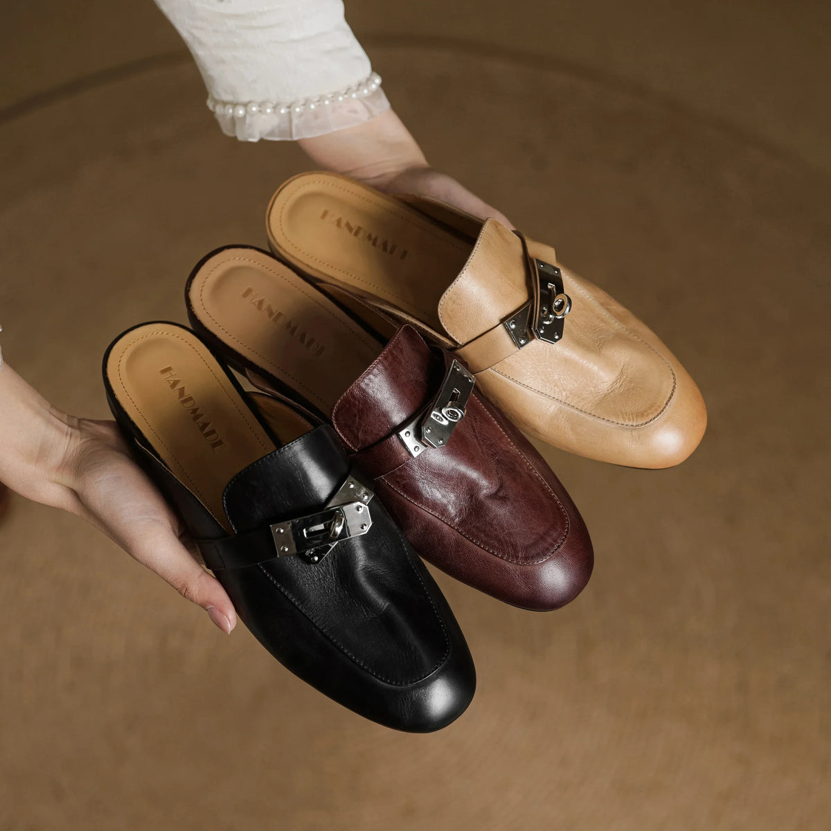 Set of leather mules in apricot, maroon, and black with silver buckle straps