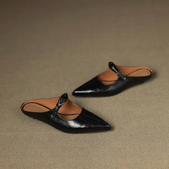 Black leather pointed-toe mules with slingback strap and silver buckle