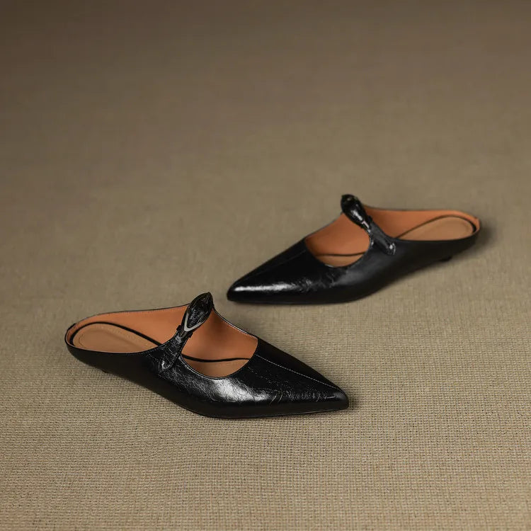Black leather pointed-toe mules with slingback strap and silver buckle