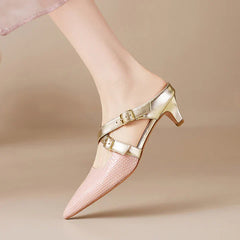 Pink textured leather mule showing side straps, gold buckles, and pointed toe.