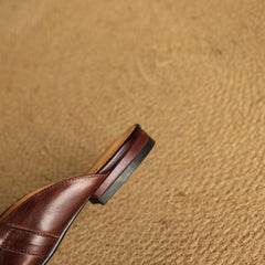Maroon leather mule strap detail with low heel and dark sole