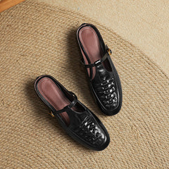Pair of leather mules in black and brown with lace-up front and low heel