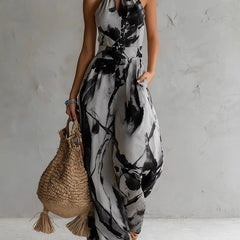 Black-and-white ink-wash halter jumpsuit, sleeveless wide-leg with neck tie and waist elastic.