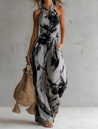 Black-and-white ink-wash halter jumpsuit, sleeveless wide-leg with neck tie and waist elastic.