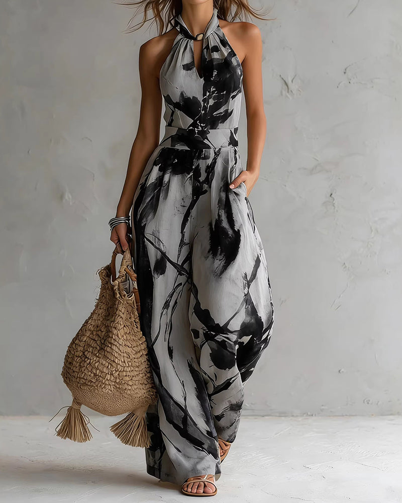 Black-and-white ink-wash halter jumpsuit, sleeveless wide-leg with neck tie and waist elastic.
