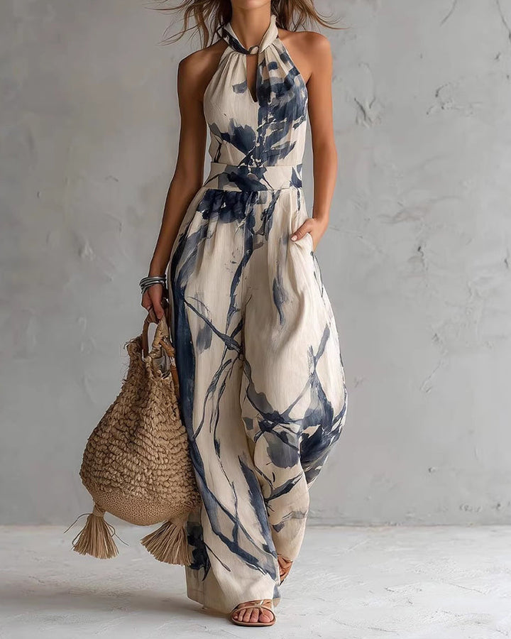 Blue ink-wash halter jumpsuit, sleeveless wide-leg with neck tie and elastic waist.