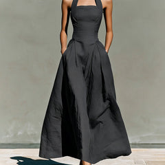 Black halter maxi dress with fitted bodice and full pleated skirt