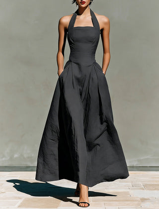 Black halter maxi dress with fitted bodice and full pleated skirt