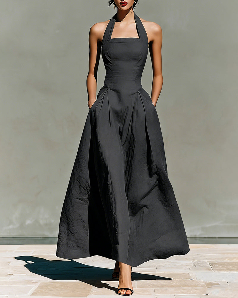 Black halter maxi dress with fitted bodice and full pleated skirt