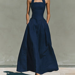 Navy blue halter maxi dress with fitted bodice and full skirt