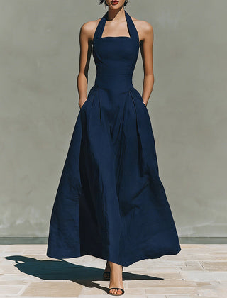 Navy blue halter maxi dress with fitted bodice and full skirt