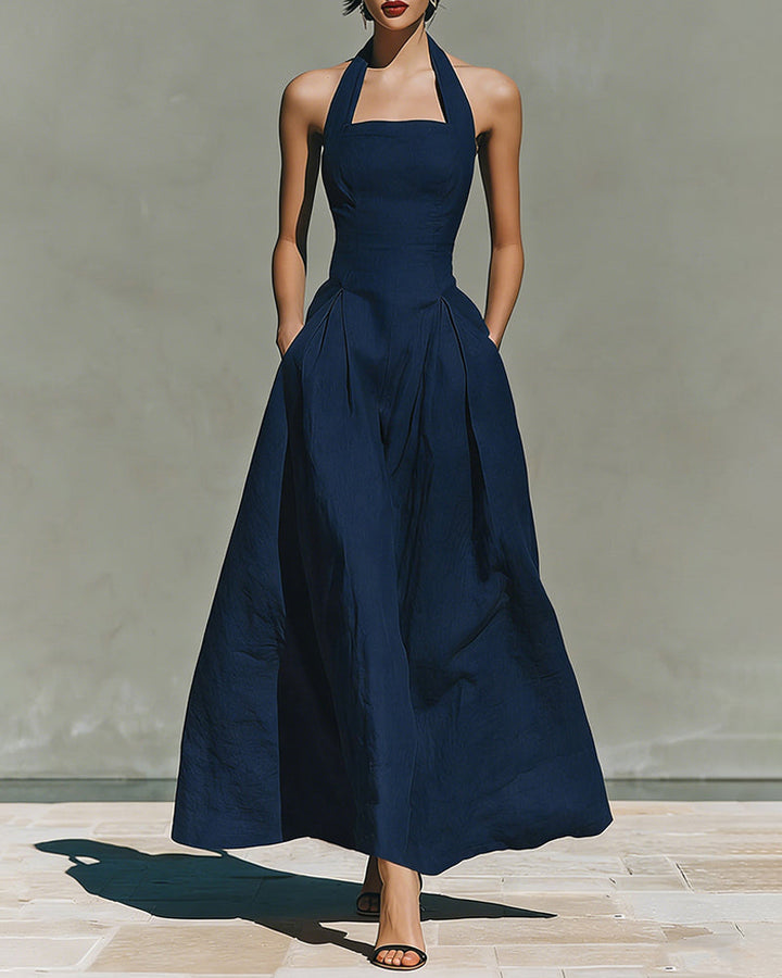 Navy blue halter maxi dress with fitted bodice and full skirt