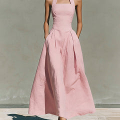 Pink linen halter dress with fitted bodice and pleated midi skirt