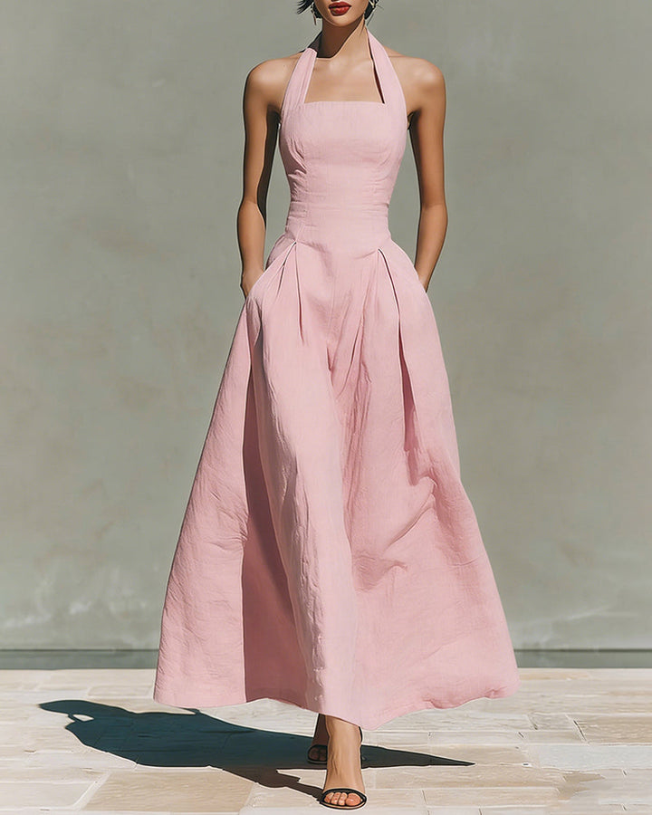 Pink linen halter dress with fitted bodice and pleated midi skirt