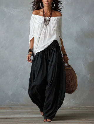 White off-shoulder top and black draped harem pants resort set with wide neckline