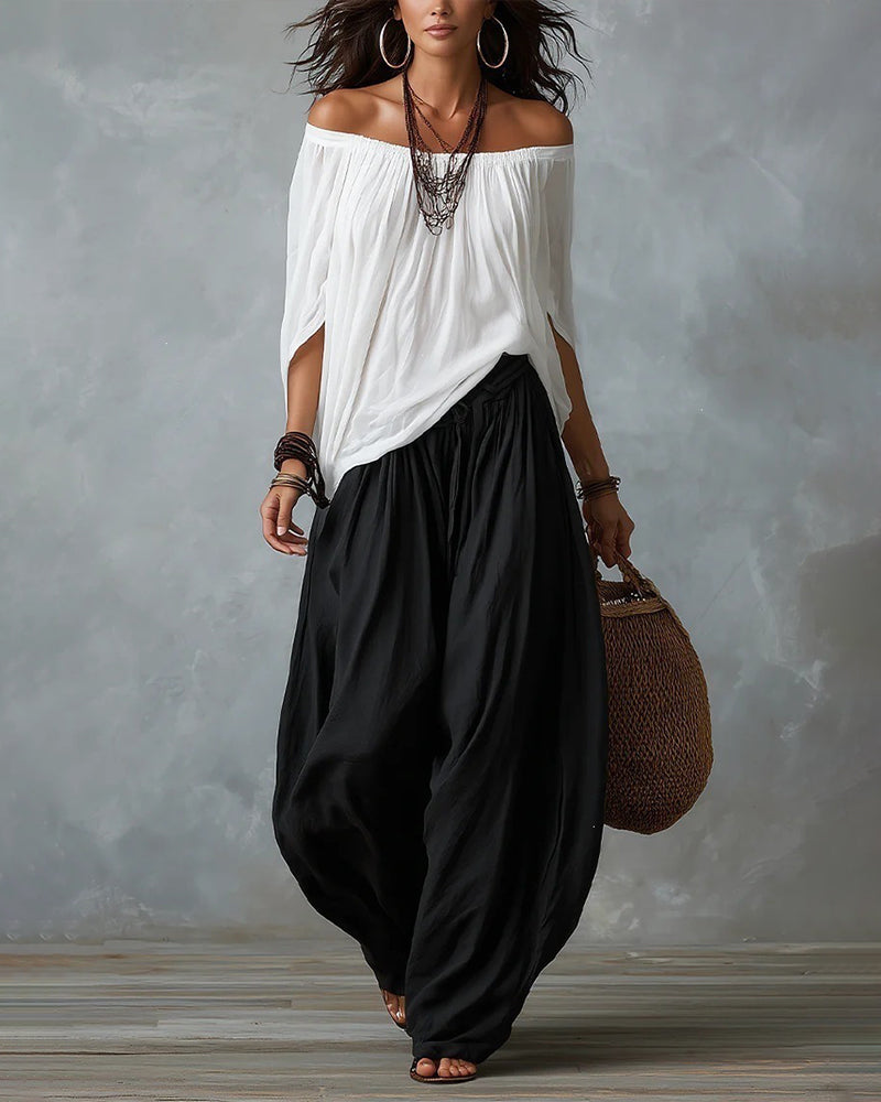White off-shoulder top and black draped harem pants resort set with wide neckline