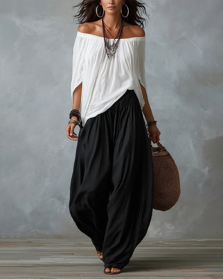 White off-shoulder top and black draped harem pants resort set with wide neckline