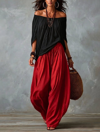 Black off-shoulder top and red draped harem pants resort set with wide neckline